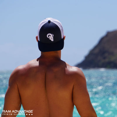JEREMY SAGE wearing RAM ADVANTAGE premium ROYAL BLUE and WHITE 3D embroidered TRUCKER HAT in HAWAII on the BEACH