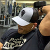 BRANDON DINOVI wearing a RAM ADVANTAGE PURE ALPHA t-shirt and premium HEATHER GREY and BLACK 3D embroidered TRUCKER HAT while working out his BICEPS