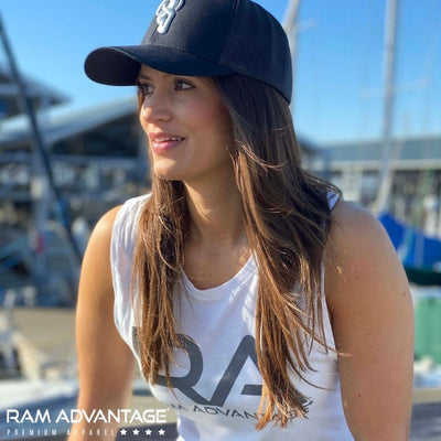 SEXY BRUNETTE overlooking the waterfront in a white RAM ADVANTAGE tank top and BLACK TRUCKER HAT